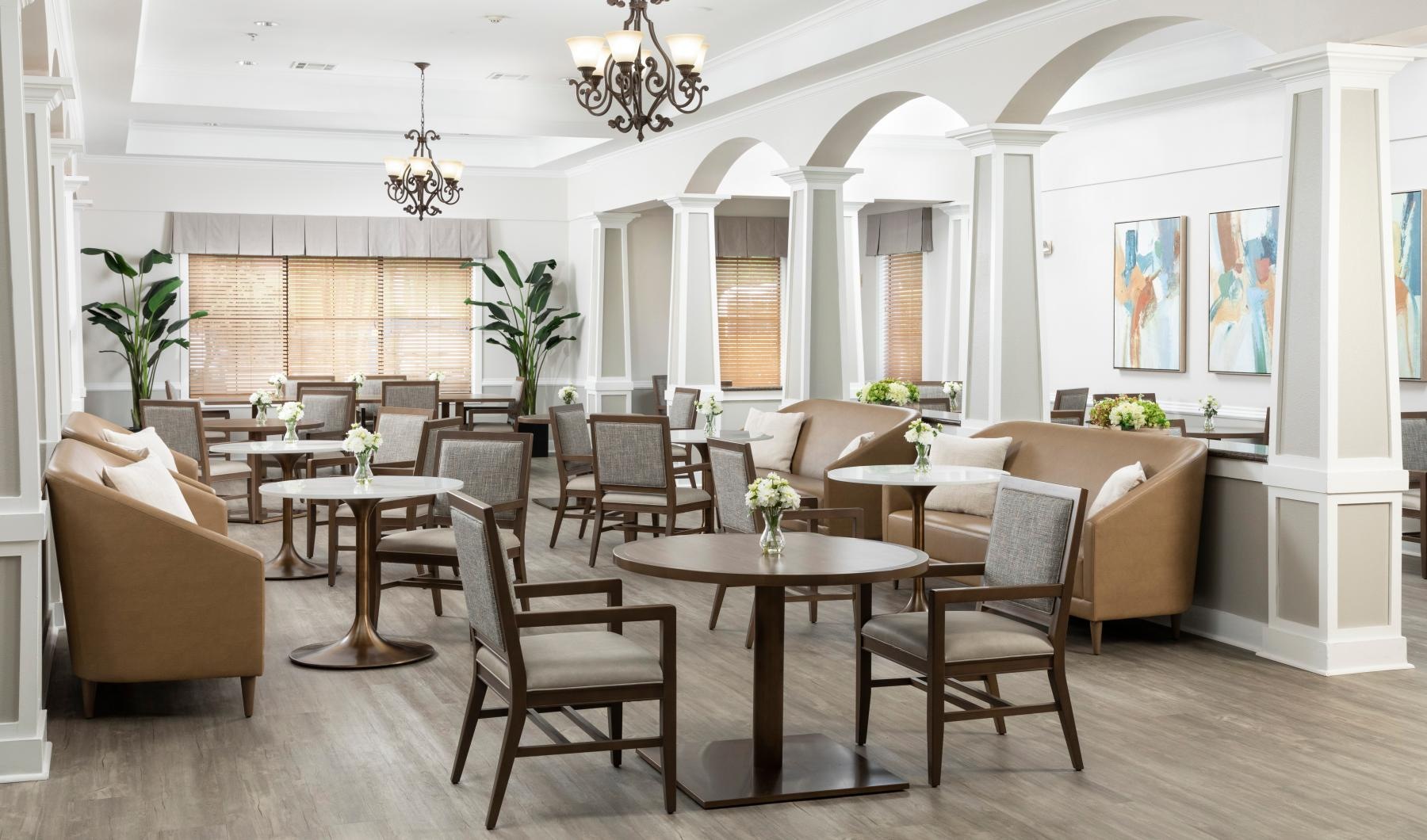 Settle into comfort at Walnut Creek Assisted Living & Memory Care a room with a table chairs and a chandelier